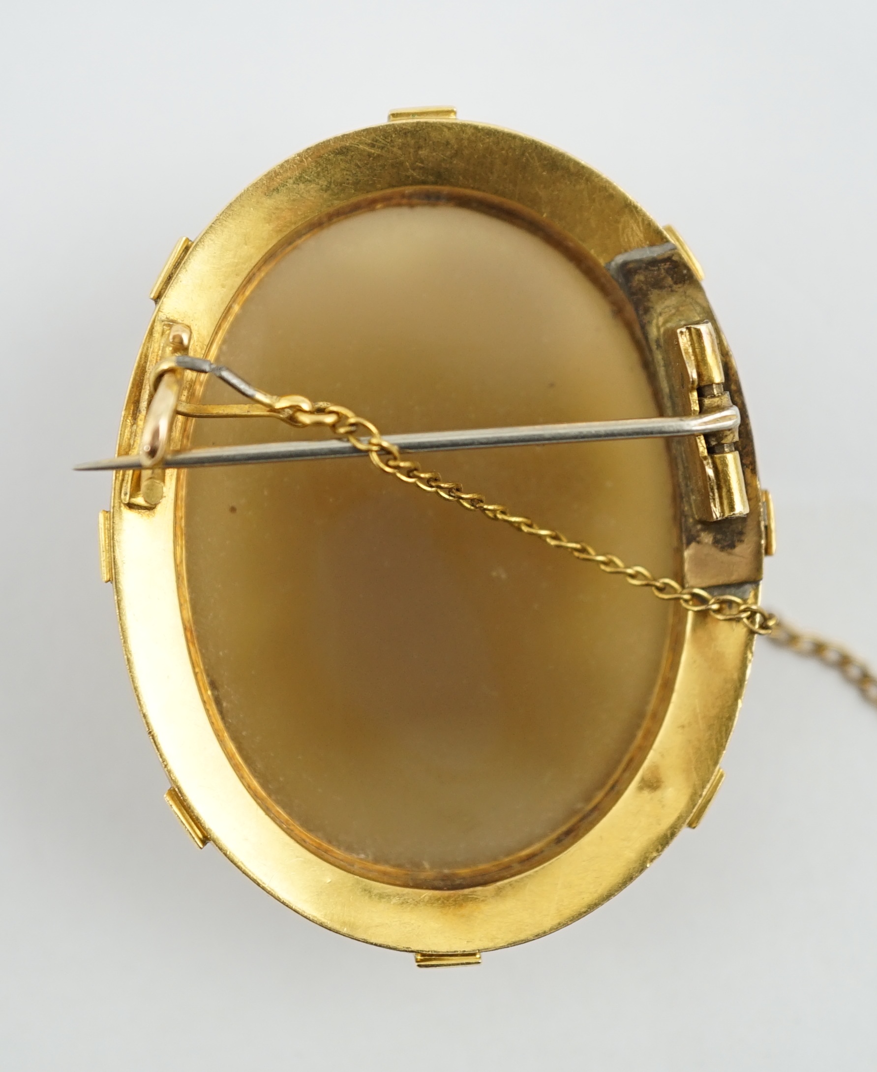 A Victorian gold, enamel and seed pearl mounted oval cameo hardstone brooch